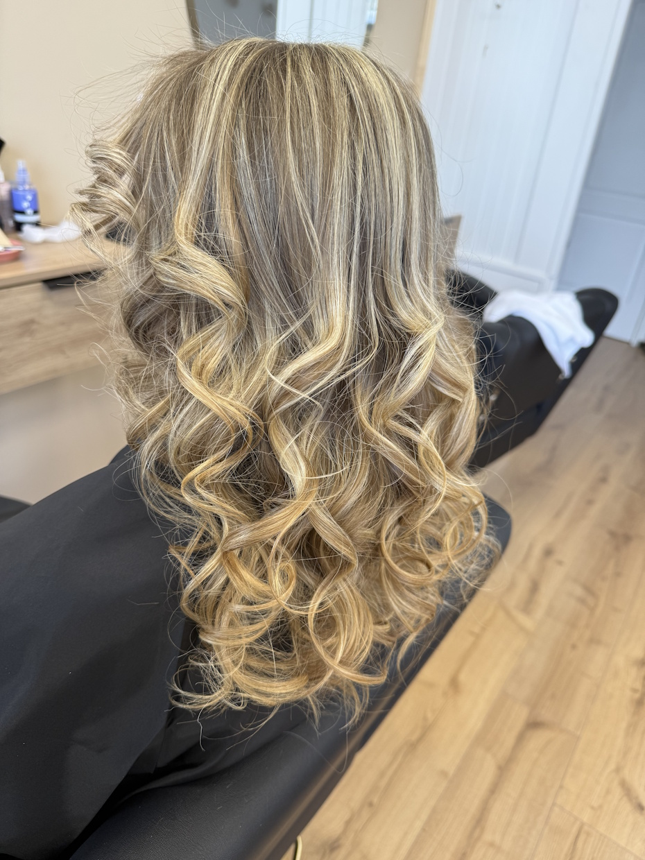 Cheveux longs blonds bouclés en salon